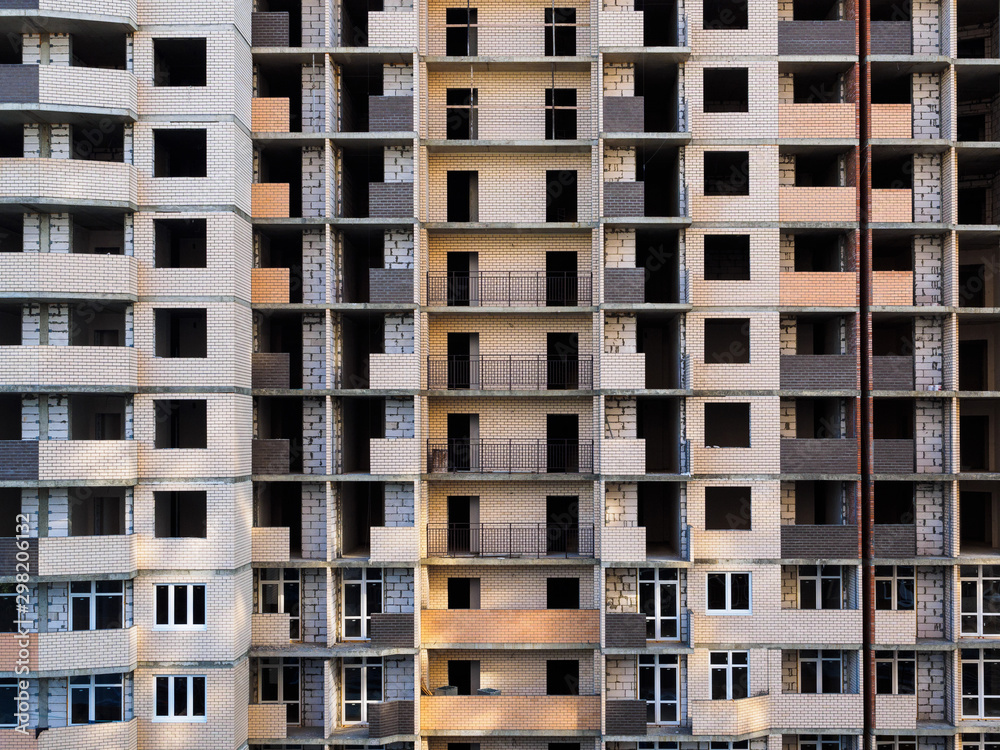 Unfinished multi-storey building. Brick building under construction Unfinished multi-storey building. Brick building under construction