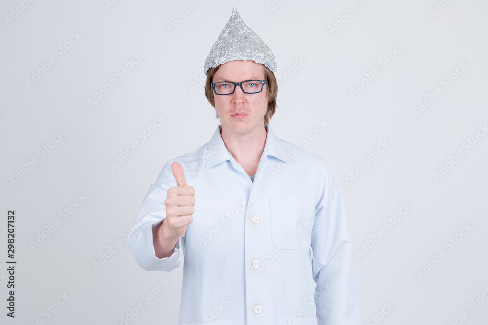 Young man doctor with tinfoil hat giving thumbs up Young man doctor with tinfoil hat giving thumbs up
