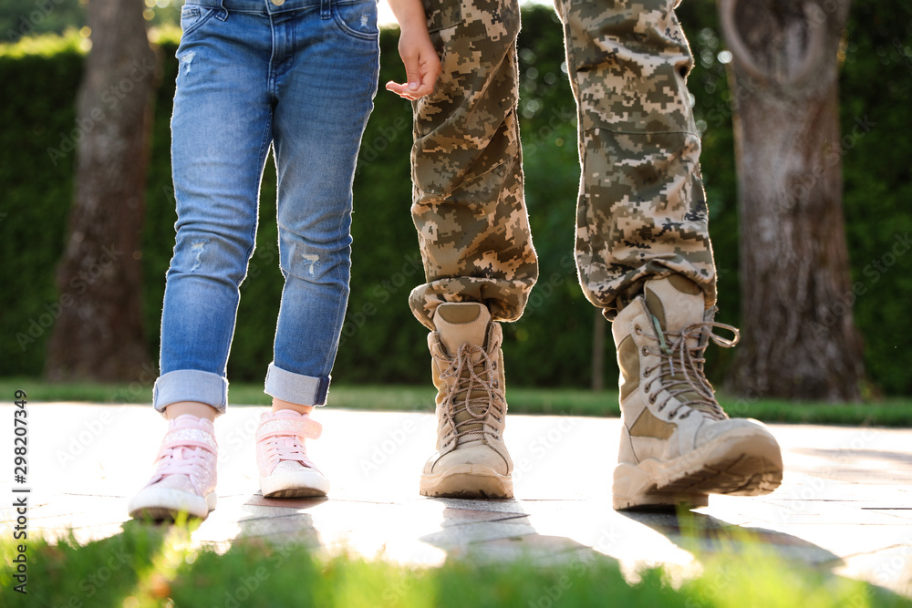Father in military uniform walking with his daughter at sunny park, closeup Father in military uniform walking with his daughter at sunny park, closeup