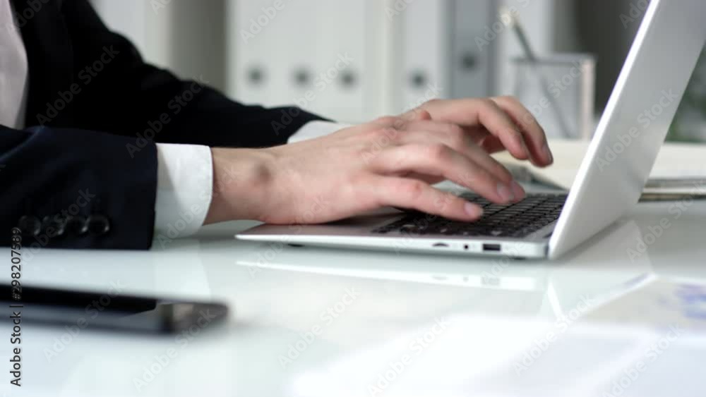 Zoom in selective focus shot of hands of unrecognizable male office worker typing on laptop while working at desk Zoom in selective focus shot of hands of unrecognizable male office worker typing on laptop while working at desk
