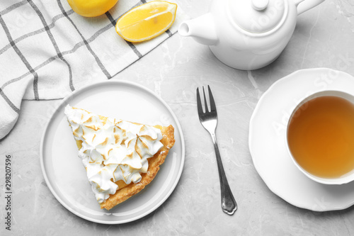 Delicious lemon meringue pie served on light grey table, flat lay
