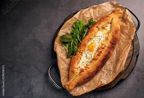 delicious Adjarian khachapuri with greens photo