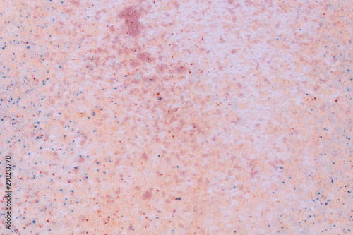 A pattern of scattered multicolored soft sand on white background