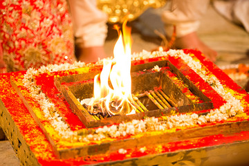 Holy fire in traditional indian hindu wedding puja ritual taking place in mandap wedlock.