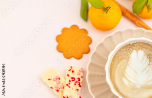 cozy winter coffee break - cappuccino, ginger cookies, chocolate, cinnamon, tangerines
