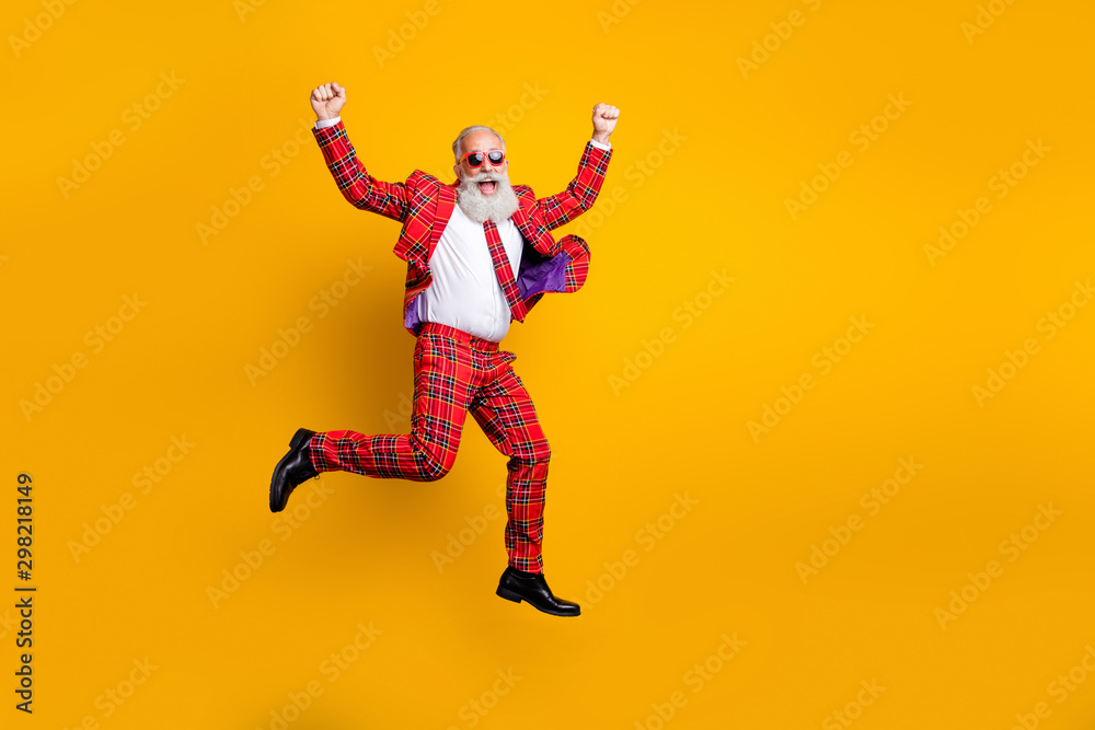 Full length body size view of nice handsome attractive cheerful cheery funky comic gray-haired man jumping having fun rejoice isolated over bright vivid shine vibrant yellow color background