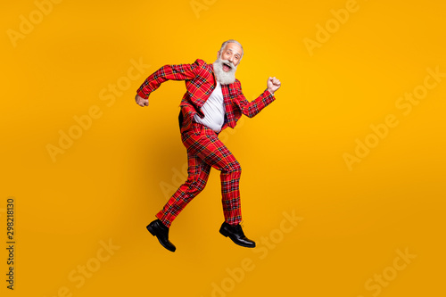 Full length body size view of his he nice handsome cheerful cheery funky comic childish gray-haired man jumping having fun running isolated over bright vivid shine vibrant yellow color background