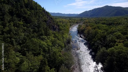 Slow aerial flight with stream of mountain river. Canyon colorful rocks. Russian wildness central Europe. Fishing travel adventure hiking. Drone cinematic photo