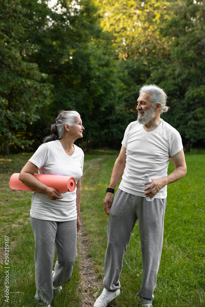 Fototapeta premium Beautiful senior couple working out together in the nature