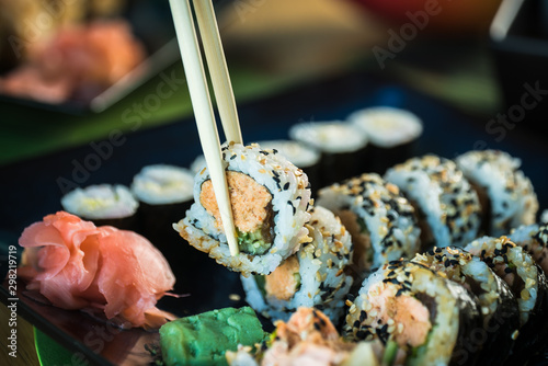 Sushi Set. Various rolls on a wooden plate. On dark rustic background
