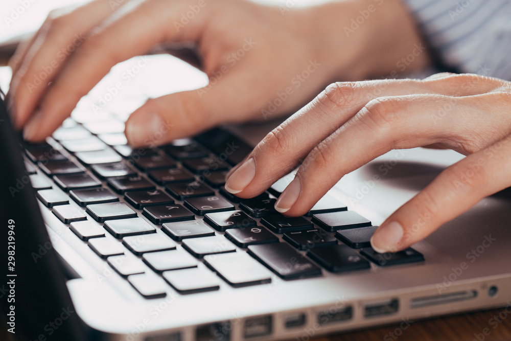 Woman working at home office hand on keyboard close up Woman working at home office hand on keyboard close up