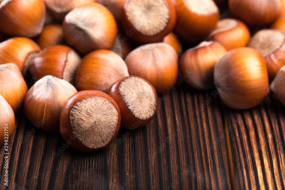close up of hazelnuts on wooden table . close up of hazelnuts on wooden table .