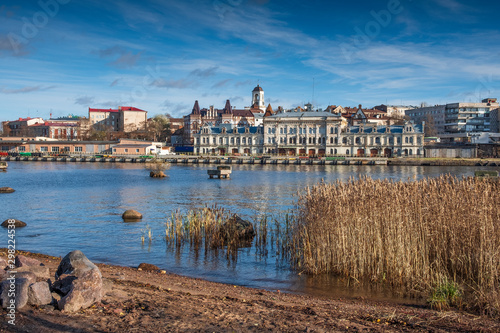 Panorama of the embankment with ancient beautiful buildings of the city of the middle-century city of Vyborg in Russia on an autumn sunny day © Lana Kray