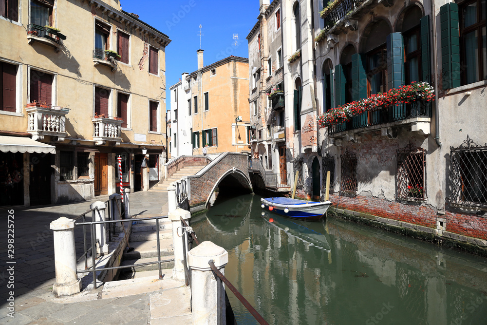 Venice, a quiet canal with a bridge crossing - Italy