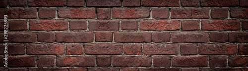 Red brick wall close-up wide texture. Old rough orange brickwork widescreen background