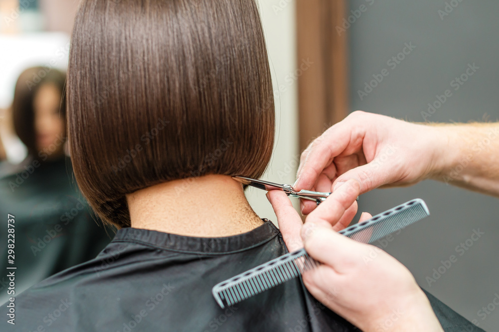 Hands of professional hair stylist is cutting hair tips with scissors and  comb. Close up hairstyle. Concept barber salon. Female stylist. Stock Photo  | Adobe Stock