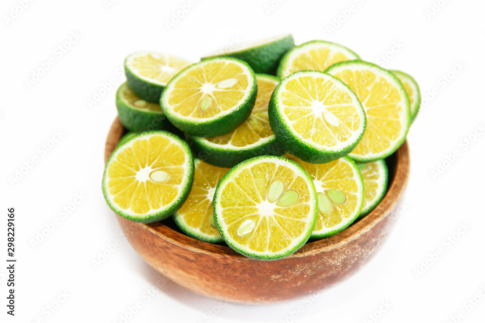 thin slices of green natural fresh mandarin orange in a wooden plate thin slices of green natural fresh mandarin orange in a wooden plate
