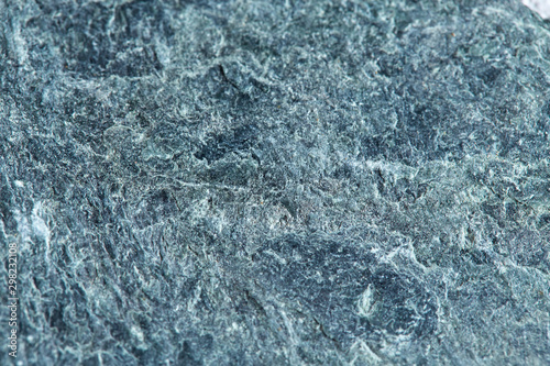 Grainy texture of greenish-gray natural stone. Natural backgrounds and textures.