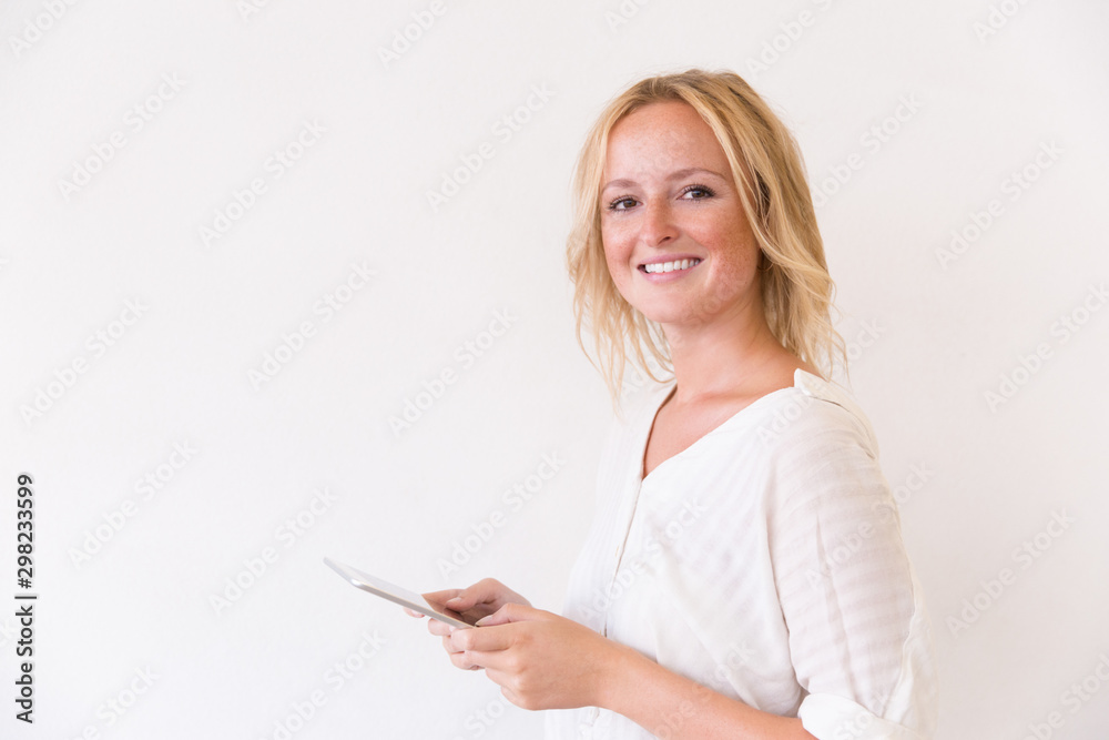 Cheerful female user using internet app on tablet. Beautiful woman in casual using digital device isolated over white background. Wireless technology concept Cheerful female user using internet app on tablet. Beautiful woman in casual using digital device isolated over white background. Wireless technology concept