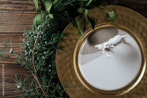 Holiday Gold place setting, decorated with pine branches. wooden background photo