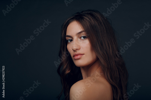 Portrait of beautiful young brunette woman with healthy hair