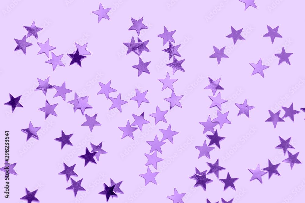 Purple star confetti on a pastel purple background- monochrome Christmas festive backdrop Purple star confetti on a pastel purple background- monochrome Christmas festive backdrop