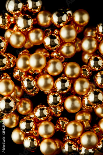 top view of shiny golden Christmas balls isolated on black