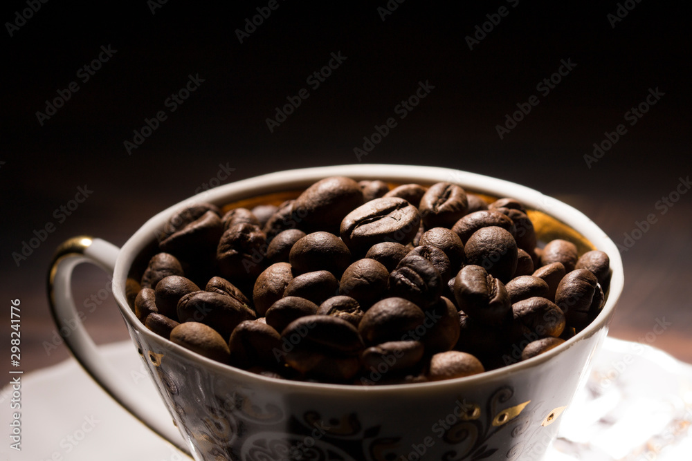 Fototapeta premium coffee bean filled mug , close up . coffee beans background 