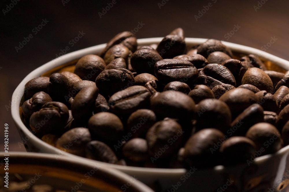 Fototapeta premium coffee bean filled mug , close up . coffee beans background 