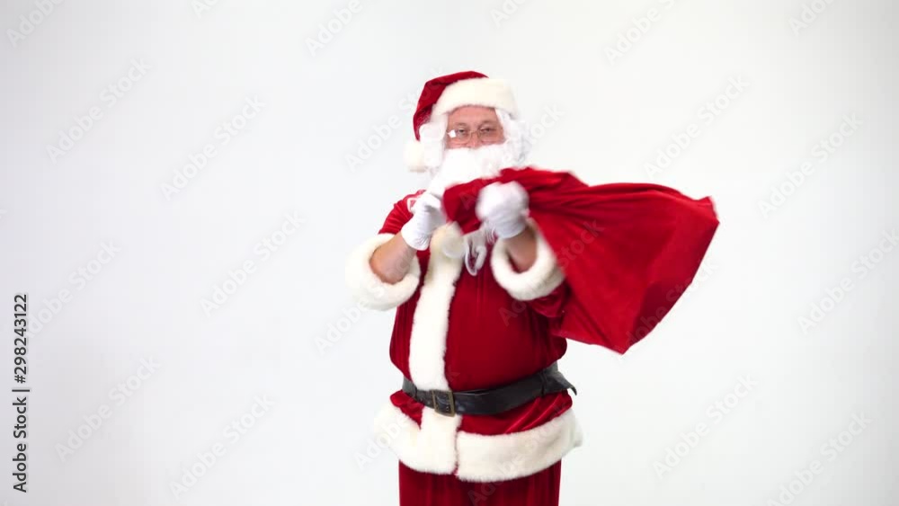 Christmas. Santa Claus on a white background takes out a red box with a bow from a bag, gives it. Present. Surprise. Christmas. Santa Claus on a white background takes out a red box with a bow from a bag, gives it. Present. Surprise.