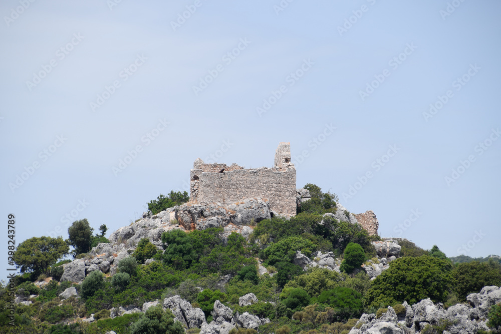 ruins of an ancient fortress on top of a cliff. Kekova Turkey city ruins.