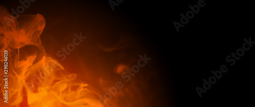 Black background with smoke and orange light for entering text for the Halloween party with copy space photo