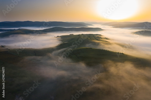 Misty sunrise with sunrays over the hills in Transylvania  Romania.