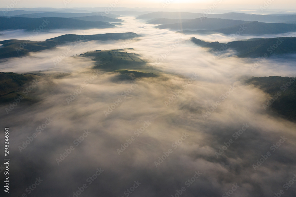 Misty sunrise with sunrays over the hills in Transylvania, Romania. Misty sunrise with sunrays over the hills in Transylvania, Romania.