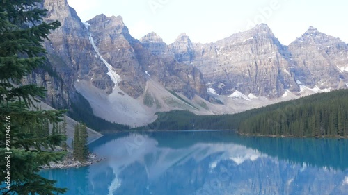 Landscape view of the Moriane Lake -one of the most famous lake in Canada- in the early morning with reflection of the rockie mountain range on the lake's surface in Banff national park,Alberta,Canada photo