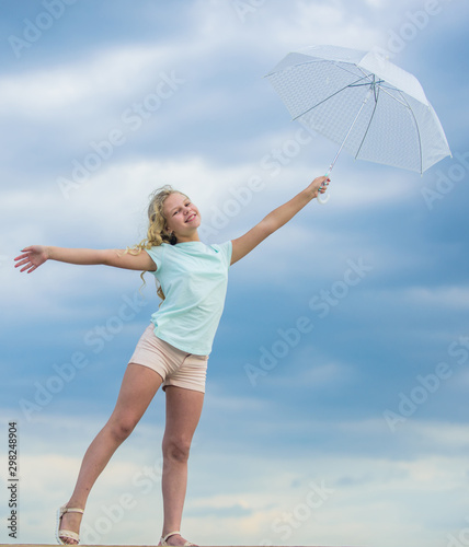 Happy to be around. happy small girl with umbrella. positive mood at any weather. school time. autumn season. rainy weather forecast. fall kid fashion. child at cloudy sky. rain protection