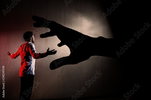 silhouette of man facing the shadows