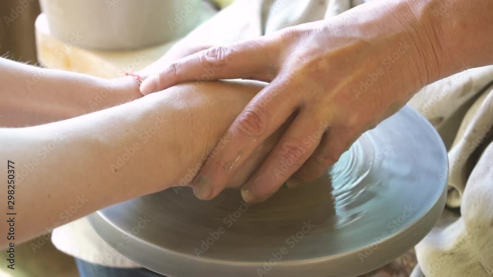 Woman making cup on pottery wheel Woman making cup on pottery wheel