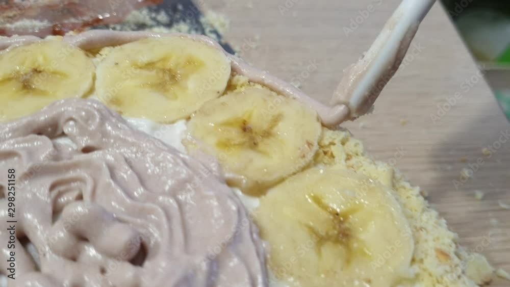 cooking cake at home, applying the cream on the cake with bananas cooking cake at home, applying the cream on the cake with bananas