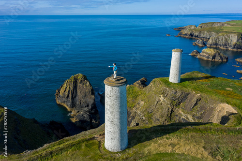 Aerial view, The Metal Man is a 3-metre tall cast-metal figure of a sailor pointing seawards. According to local lore, he is said to warn seafarers away from dangerous shallow waters.