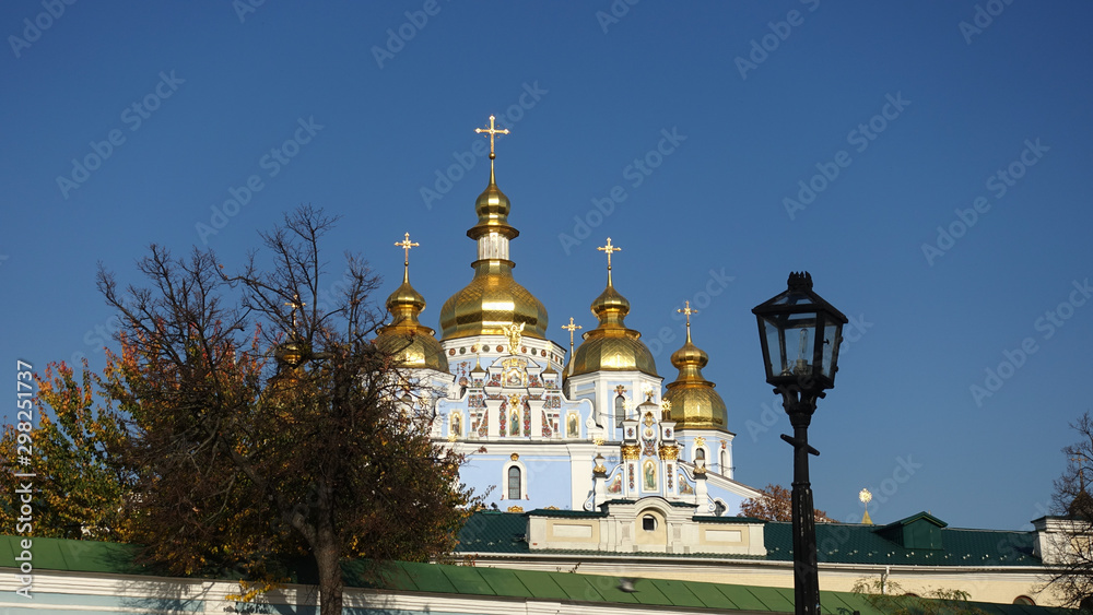 Domes of St. Michael's Golden-Domed Cathedral in Kiev against a blue sky