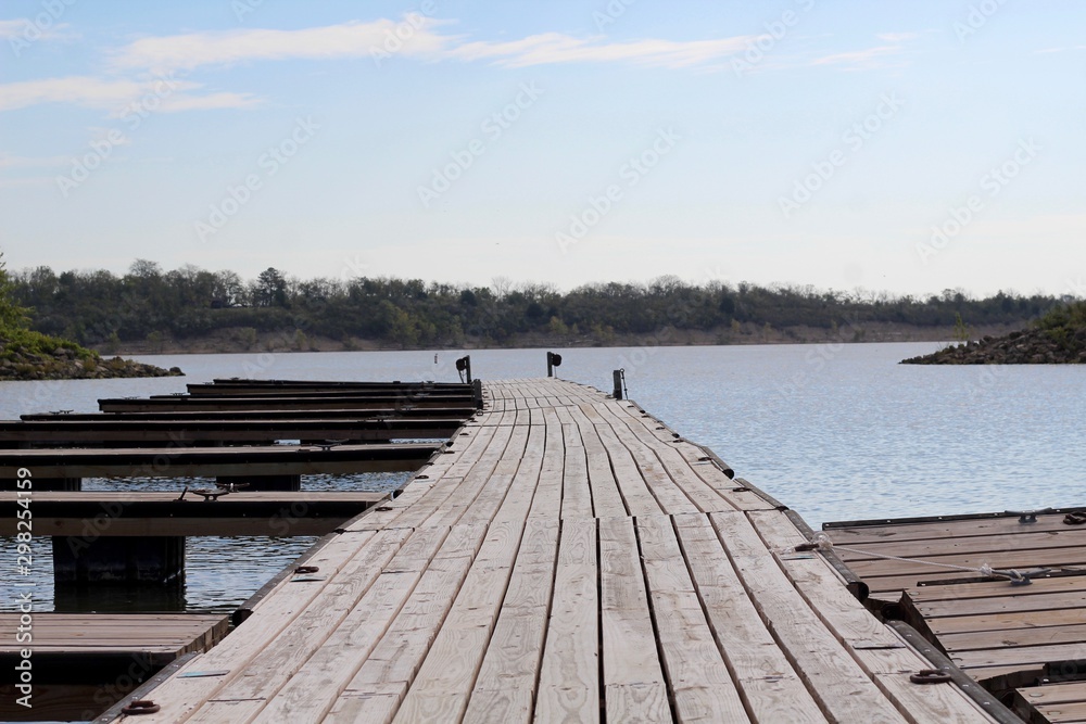 Fototapeta premium A view of the long empty pier at the lake.