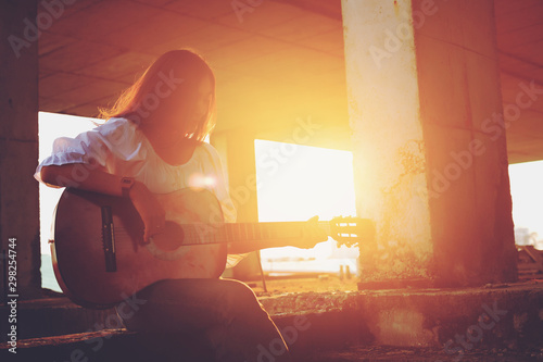 Candid silhouette woman chill play acoustic guitar musician .Artists female sad mood activity music