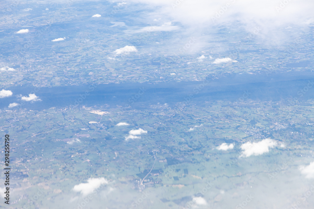 Obraz premium Clouds, sky and ground, looking from the plane.