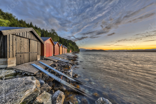 Sunset with Colorful Boathouse in Norwegian fjord photo