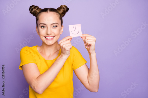 Closeup photo of pretty lady holding paper sticker with smile painting expressing best weekend mood wear yellow t-shirt isolated pastel purple background