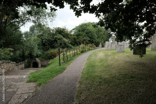 Typically designed English cemetery showing a path leading to an out of view church.