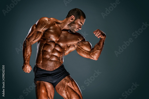 Handsome Muscular Bodybuilder Flexing Muscles