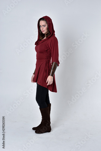 Obraz na plátně full length portrait of a brunette girl wearing a red fantasy tunic with hood