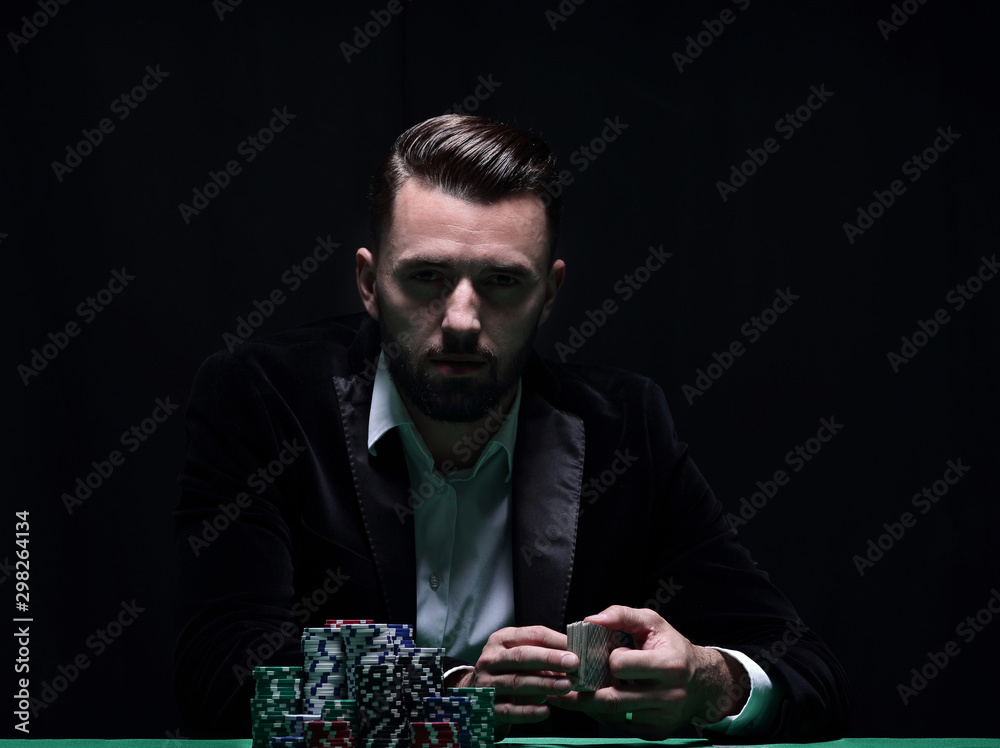 A wealthy man playing poker with the excitement in a casino. - obrazy, fototapety, plakaty 